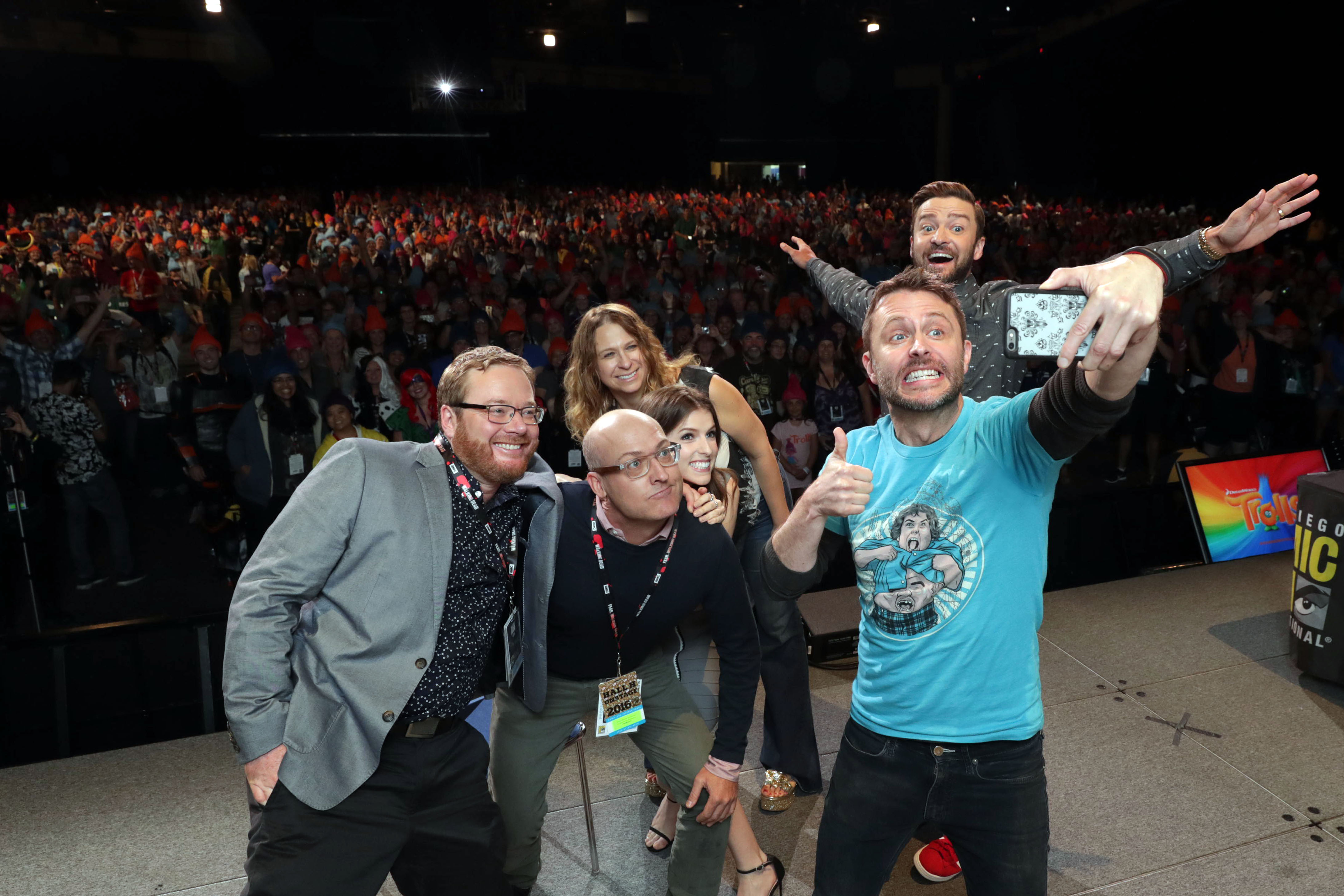 TROLLS filmakers and voice actors take a selfie with the audience at DreamWorks Animation's Comic Con Hall H Panel. (from left) Co-Director Walt Dorn, Director Mike Mitchell, Anna Kendrick, Producer Gina Shay, Moderator Chris Hardwick, and Justin Timberlake.